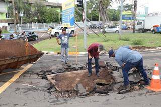 Secretário Rudi Fiorese faz avaliação de asfalto arrancado por enxurrada. (Foto: Paulo Francis)