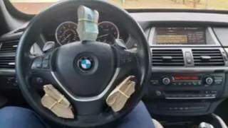 Imagem extraída de telefone celular de um dos envolvidos mostra transporte de dinheiro vivo em BMW. (Foto: Reprodução de processo)