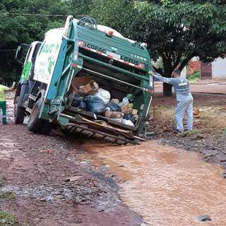 Caminhão de coleta de lixo ficou atolado na lama no Jardim Carioca. (Foto: Direto das Ruas)