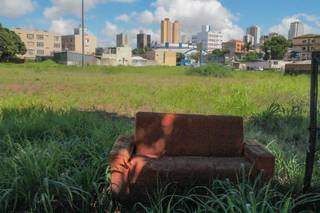 Terreno, que tem até sofá descartado, é um vazio urbano no Centro de Campo Grande. (Foto: Marcos Maluf)