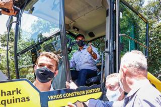 Governador Reinaldo Azambuja sobe em máquina agrícola durante entrega do equipmento (Foto: Henrique Kawaminami)