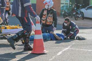 No chão, a vítima que estava na moto, recebe atendimento da equipe do Samu. (Foto: Marcos Maluf)