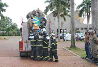 Bombeiros tiram o caixão com o corpo do colega de farda da viatura, na chegada ao cemitério. (Foto: Paulo Francis)