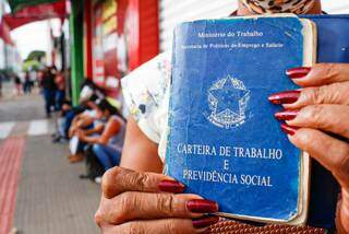 Candidata segurando a carteira de trabalho. (Foto: Henrique Kawaminami)