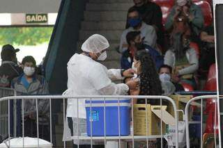Mulher é vacinada em posto montado no Guanandizão (Foto: Marcos Maluf)