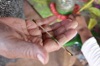 Na falta de pincéis verdadeiros, Cléa improvisa pintura com palitos de bambu. (Foto: Marcos Maluf)