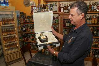 O proprietário Fernando Soares mostra a garrafa mais cara do local, que custa R$ 8 mil. (Foto: Paulo Francis)