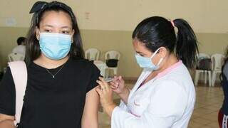 Jovem recebe dose de vacina contra o coronavírus no polo montado na Seleta. (Foto: PMCG)