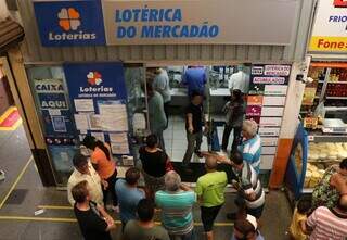 Clientes sendo atendidos na lotérica do Mercadão, na Capital. (Foto: Henrique Kawaminami)