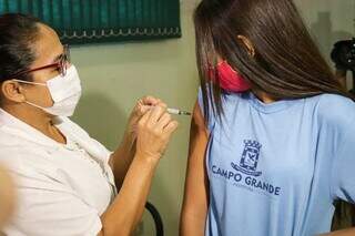 Criança é vacinada contra a covid-19 em Campo Grande. (Foto: Henrique Kawaminami)