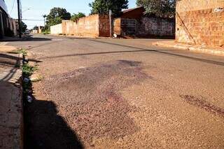 Manchas de sangue no local onde rapaz foi assassinado. (Foto: Henrique Kawaminami)