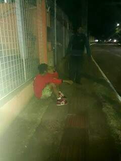 Ladrão sentado na calçada momento antes de invadir loja (Foto: Direto das Ruas)