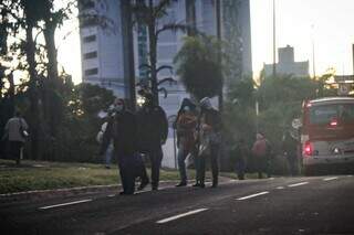 Pedestres, todos com agasalhos, atravessam a Avenida Afonso Pena. (Foto: Henrique Kawaminami)