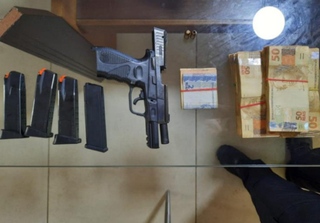 Pistola, carregadores e dinheiro encontrados na casa do policial Molina (Foto: Reprodução)