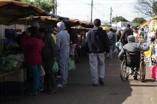 Moradores agasalhados em feira do Bairro Nova Lima na manhã do último domingo (12). (Foto: Kísie Ainoã)