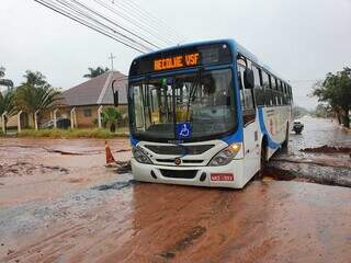 Ônibus da linha Anache/Nova Bahia ficou preso no buraco aberto no cruzamento de ruas. (Foto: Ana Oshiro)