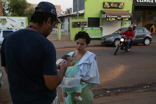Jovem oferece o doce para as pessoas que encontra nas ruas do bairro. (Foto: Kísie Ainoã)