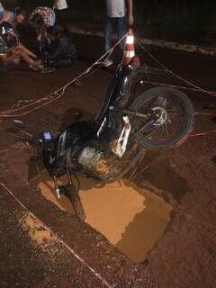 Motocicleta caiu dentro de buraco feito na via. (Foto: Direto das Ruas)