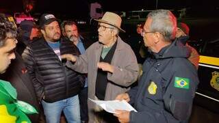 Chefe da PRF de Dourados levou cópia da decisão judicial ate manifestantes. (Foto: Adilson Domingos)
