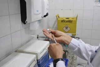 Profissional de saúde prepara vacinação com ampola de imunizante. (Foto: Arquivo/Campo Grande News)