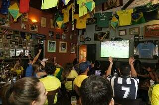 Torcedores assistem ao jogo do Brasil contra Camarões no bar Mecearia, em Campo Grande (Foto: Kísie Ainõa)