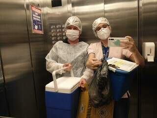 Segurando o celular, Marcele e colega de trabalho fizeram a imunização contra covid-19 de acamados, na Capital. (Foto: Arquivo Pessoal)