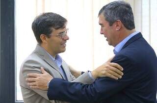 O diretor da empresa, Mário José de Souza Neto, e o governador Eduardo Riedel se cumprimentam em reunião. (Foto: Saul Schramm/Governo do Estado)