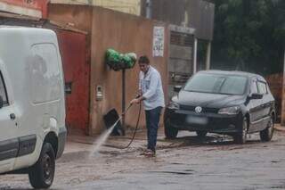 No Vespasiano Martins, a chuva não impediu Ari de fazer a limpeza da calçada. (Foto: Marcos Maluf)
