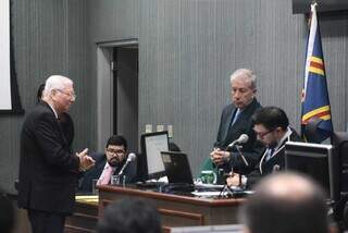 Defensor público Ronald (de óculos em pé) conversando com o juiz, Carlos Alberto Garcete, que está sentado anotando alguma coisa (Foto: Marcos Maluf)