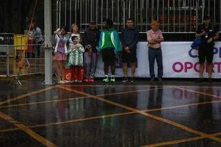 Debaixo de chuva, público assiste corrida do facho e espera por desfile (Foto: Henrique Kawaminami)