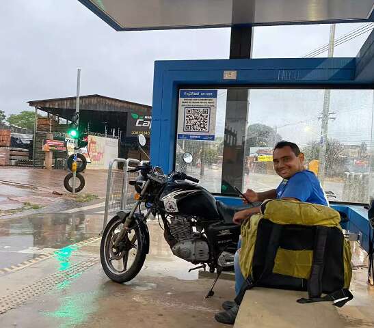  Pegos de surpresa, motociclistas se abrigam para escapar de chuva