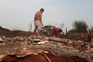 Moradores fazendo a limpeza do que sobrou da favela incendiada (Foto: Marcos Maluf)