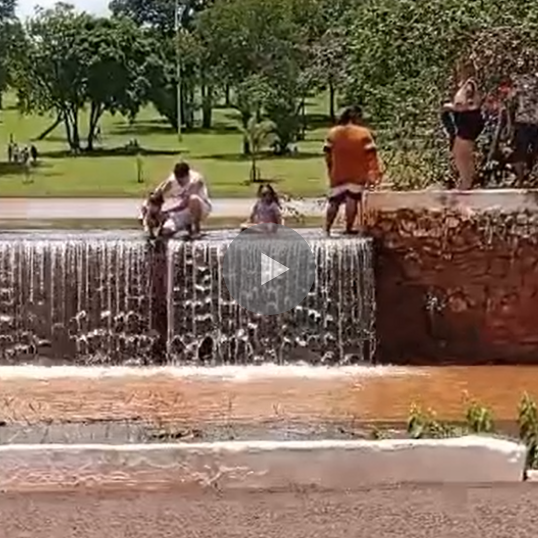 Apesar de ser proibido, família se refresca em queda d'água no Parque das Nações