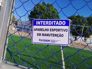 Placa que foi colocada no portão da quadra de grama sintética em Coxim (Foto: Sidney Assis, de Coxim) 