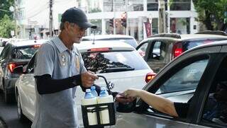 Idenir realiza venda de água entre os carros (Foto: Alex Machado)