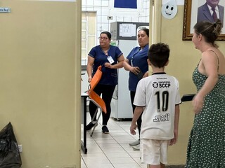 Mãe levando o filho para vacinar contra a dengue em Campo Grande (Foto: Marcos Maluf)