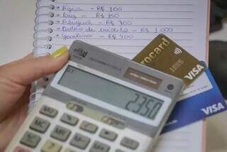 Contas anotadas em caderno junto com dois cartões de crédito (Foto: Marcos Maluf/ Arquivo)
