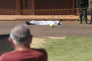 Corpo de Rikelmy coberto por lençol na rua onde foi executado a tiros (Foto: Marcos Maluf | Arquivo)