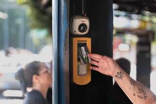 Passageira usa cartão para pagar passe de ônibus (Foto: Marcos Maluf)