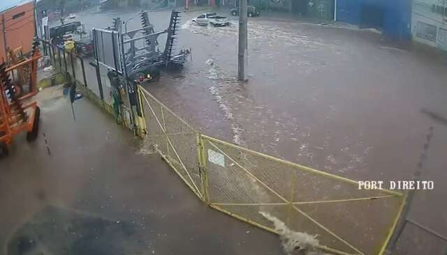 Com 30 minutos de chuva, ruas alagam e &aacute;gua invade com&eacute;rcio em avenida