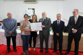 Desembargador Sérgio Martins entrega documentação de imóvel para moradora do loteamento Morada do Sol, em Fátima do Sul (Foto: divulgação TJMS)