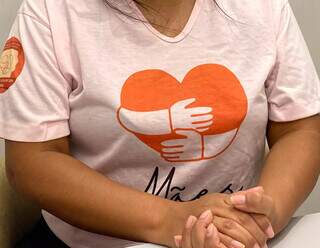 A mãe veste camiseta do projeto que fundou após perder a filha, o Mães que Acolhem com Amor (Foto: Cassia Modena)