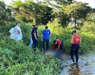 Equipes dos bombeiros ajudam na retirada do cadáver encontrado no Rio Paraná. (Foto: Reprodução/Cenário MS)