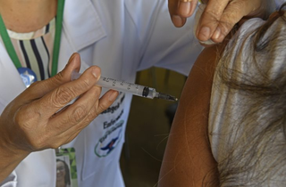 Mulher recebe dose da vacina contra a gripe em unidade básica. (Foto: Bruno Rezende)