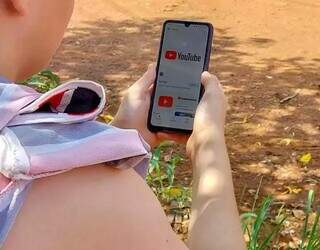 Criança utilizando o celular para acessar o Youtube (Foto: Juliano Almeida)