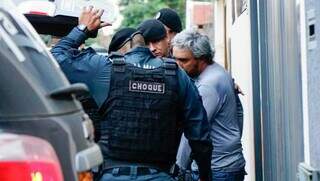 Momento que policiais do Batalhão de Choque levam suspeito da casa dele para a Deam (Foto: Alex Machado)