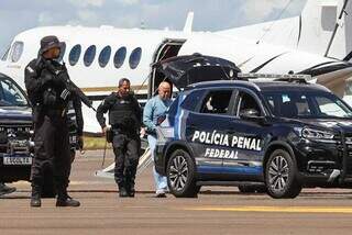 Chiquinho Brazão escoltado ao descer de aeronave em Campo Grande (Foto: Henrique Kawaminami) 