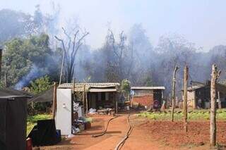 Atrás dos barracos da aldeia Água Bonita, área de mata exala fumaça (Foto: Paulo Francis)