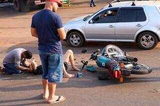 Homem segura cabeça do motociclista para não causar mais dores (Foto: Henrique Kawaminami)