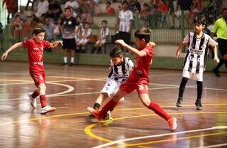 Jogadores da Escolinha Bayern (de vermelho) jogando contra o DEC Futsal (Foto: Divulgação) 